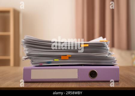 Stack of documents and office folder on wooden table indoors Stock Photo