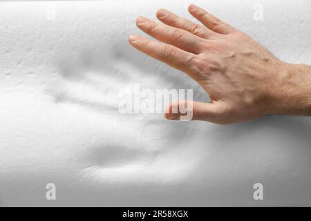 Man with orthopedic memory foam pillow, above view Stock Photo