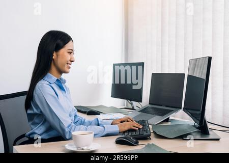Asian young female programmer working developer programing on a computer code at office. Stock Photo