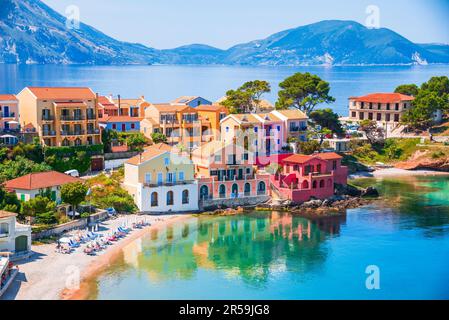 Assos, Greece. Picturesque village nestled on the idyllic Cephalonia, Ionian islands. Turquoise colored bay, Mediterranean Sea, beautiful colorful hou Stock Photo