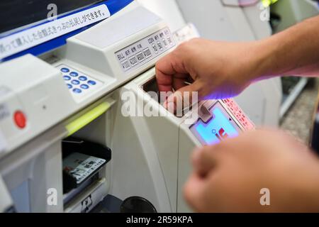 Traveler buying tickets for Kyoto Municipal Subway train in Kyoto, Japan. Stock Photo