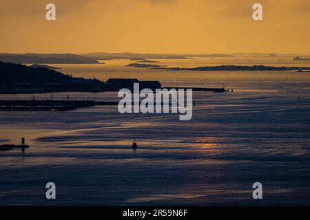 Sunset light over ling piers and an archipelago in the horizon Stock Photo