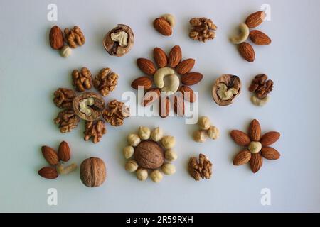 Pattern Of Almonds, Hazelnuts, Cashew And Walnuts Laid Out In A Shape Of Flowers Top View Stock Photo