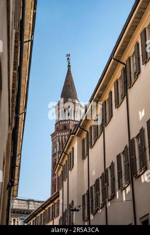 Glimpse of the bell tower of the church San Gottardo in Corte seen from 'Palazzo Reale street' near Milan Cathedral, Milano city center, Italy Stock Photo