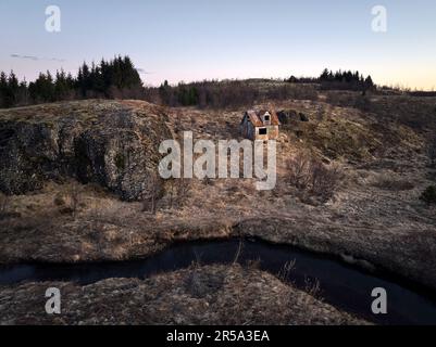 Small shabby house on hill in countryside Stock Photo