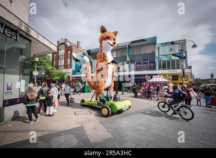 London, UK. 2nd June 2023. Farrah the Fox, a five-metre tall puppet on a giant scooter, sets off in Woolwich to celebrate England’s high streets this summer. Part of Hi! Street Fest by Historic England, a landmark nation-wide commission with Emergency Exit Arts bringing people together to celebrate what’s special about our high streets. Credit: Guy Corbishley/Alamy Live News Stock Photo