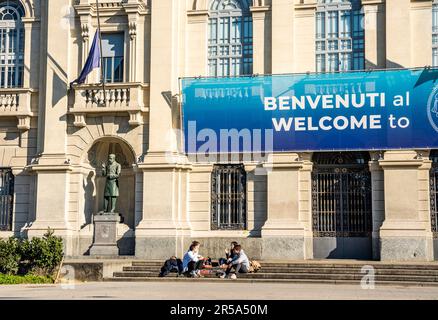 Two students in front of Polytechnic University of Milan, main campus 'Milan Leonardo', in Città studi district, Milano Italy Stock Photo