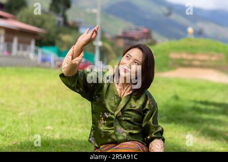 A performer from the Royal Academy of Performing Arts (RAPA) in Thimphu, Bhutan, gracefully demonstrates traditional Bhutanese dance. Stock Photo