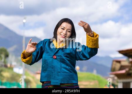 A performer from the Royal Academy of Performing Arts (RAPA) in Thimphu, Bhutan, gracefully demonstrates traditional Bhutanese dance. Stock Photo