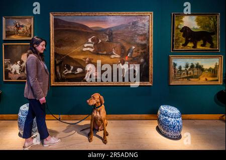 London, UK. 2nd June, 2023. Zen (3yr old dog and his owner with ENGLISH SCHOOL, LATE 17TH CENTURY, Hounds and monkeys trapping partridge in a landscape, Estimate GBP 15,000 - GBP 20,000 and other dog works - Preview of the Christie's Robin and Rupert Hambro Collection which will be in a live auction on 8 June in London. This collection is from Ebury Street in London, Copse Farm in Hampshire and Saint-Rémy in Provence. Credit: Guy Bell/Alamy Live News Stock Photo