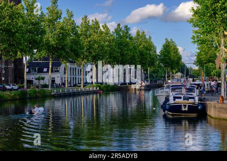 Weesp, Netherlands - July 05. 2022. Trees lining the Herengracht canal on a summers evening Stock Photo