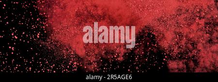 red particles flying, colored powder isolated on black background banner Stock Photo