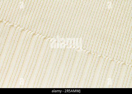 Textured background of beige knitted cotton or wool fabric pattern, close-up Stock Photo