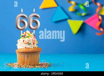 Candle number 66 - Cake birthday in blue background Stock Photo