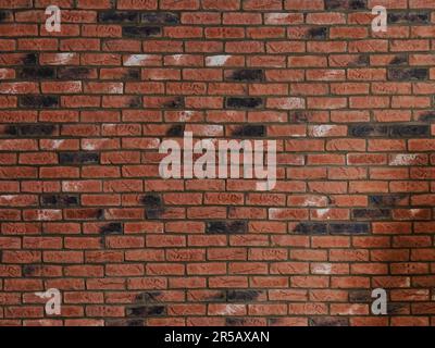 Red brick wall texture with dark weathered bricks and horizontal masonry pattern, suitable as an architectural background, urban surface or constructi Stock Photo