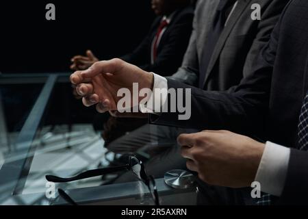 Business partners discuss financial reports, plan an investment strategy. Team of three Stock Photo