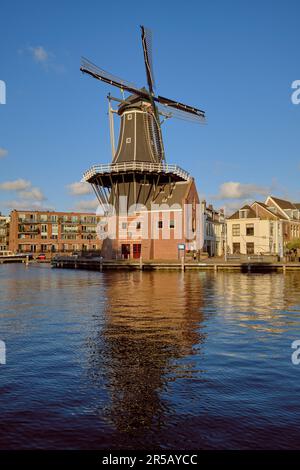 HAARLEM, NETHERLANDS - MAY 24, 2022: The famous Adriaan Windmill on the river De Spaarne on a clear day. Stock Photo