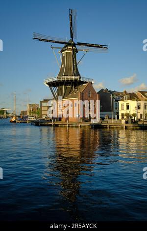 HAARLEM, NETHERLANDS - MAY 24, 2022: The famous Adriaan Windmill on the river De Spaarne on a clear day. Stock Photo