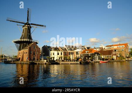 HAARLEM, NETHERLANDS - MAY 24, 2022: The famous Adriaan Windmill on the river De Spaarne on a clear day. Stock Photo
