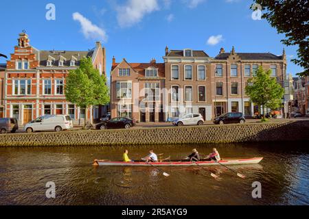 HAARLEM, NETHERLANDS - MAY 24, 2022: Members of an canoe club participate in an evening workout session on the Kampersingel canal. Stock Photo