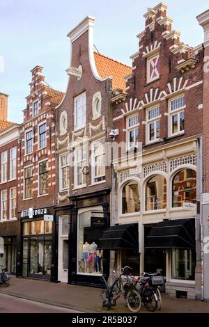 Haarlem, The Netherlands - April 11, 2022: Modern shops set in historic buildings with traditional Dutch gables on Zijlstraat street in the city centr Stock Photo