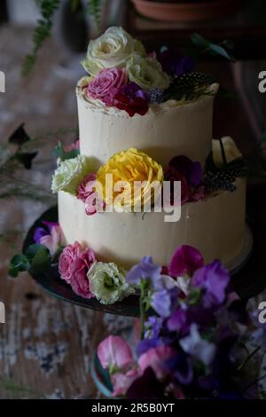 Wedding cake decorated with flowers. Stock Photo
