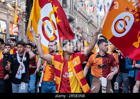 Young people walking with Galatasaray flags, celebration of Galatasaray championship in Istanbul, fans celebrate winning Turkish Super Lig title Stock Photo
