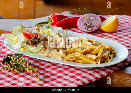 A freshly prepared meal of assorted vegetables, legumes, and grains laid out on a wooden table, ready to be eaten Stock Photo