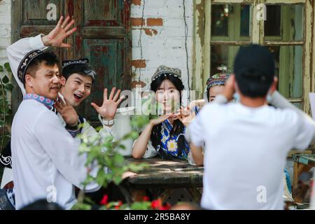 (230602) -- URUMQI, June 2, 2023 (Xinhua) -- Tourists pose for photos on Liuxing Street in Yining City, Ili Kazak Autonomous Prefecture, northwest China's Xinjiang Uygur Autonomous Region, May 17, 2023. According to comprehensive calculation through a big data platform for tourism statistics and sample survey, from January to April 2023, Xinjiang received over 51.19 million tourists, a year-on-year increase of 29.56%. Meanwhile, tourism revenue reached 42.64 billion yuan (about 6.03 billion U.S. dollars), up 60.59% year on year. (Xinhua/Hao Zhao) Stock Photo