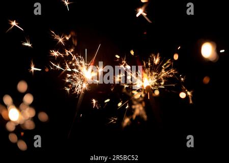 Burning two sparklers, abstract blur background. Stock Photo