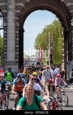 Riders pass under Admiralty Arch on The Mall during the 2023 Ford RideLondon FreeCycle cycling event in London, UK Stock Photo