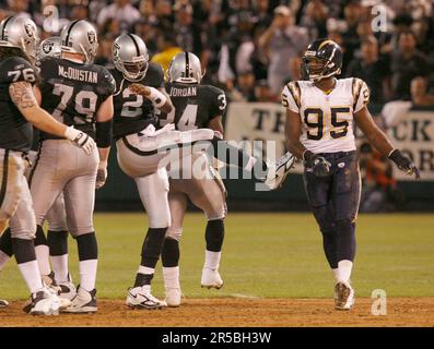 San Diego Charger Shaun Phillips (95) puts pressure on Arizona Cardinals  quarterback Kurt Warner (13) during the second quarter of the final season  game at Qualcomm Stadium in San Diego on December