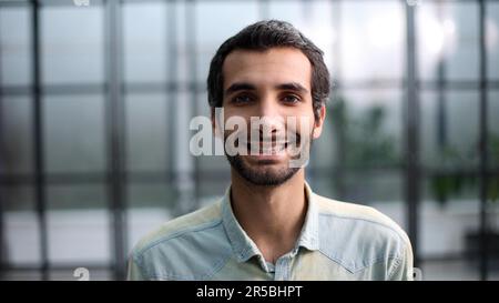 Confident young smiling businessman posing on camera Stock Photo
