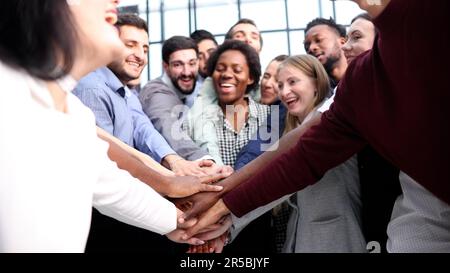 Large business team showing unity with their hands together Stock Photo