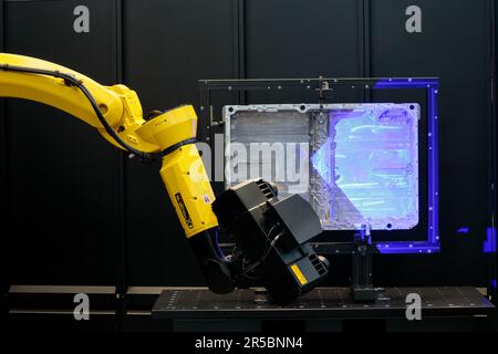 Engineer working with 3D robotic arm measuring scan automotive part in smart factory, Industry Stock Photo