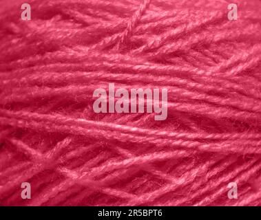 Viva Magenta thread texture closeup background. Demonstrating the colors of 2023 - Viva Magenta. Stock Photo