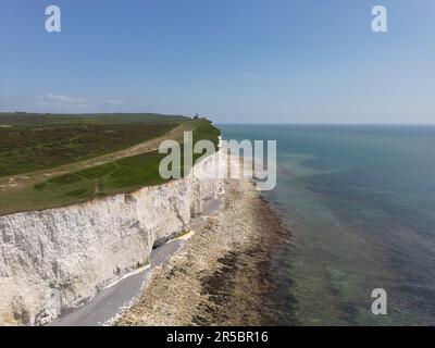 A scenic aerial view of the Seven Sisters Cliff overlooking the expanse of a blue ocean. Stock Photo