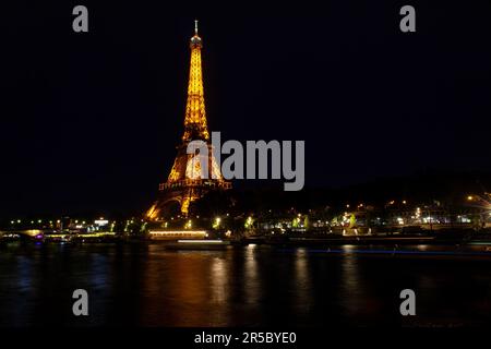 Paris, France - July, 13: Eiffel Tower brightly illuminated at dusk in Paris. It's the most visited monument of France on 13 July, 2022 Stock Photo