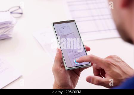 Taking Receipt Document Photo Using Phone Or Smartphone Stock Photo