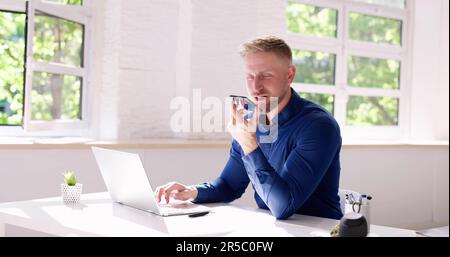 Young Man Using Voice Recognition Function On Mobile Phone Stock Photo