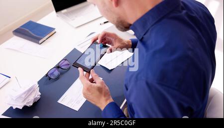 Scanning Remote Deposit Check Document Using Phone. Taking Photo Stock Photo