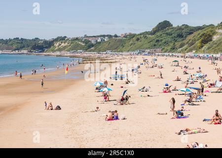 BOURNEMOUTH, UK - July 08, 2022. Sunbathers on a sandy beach in summer on the south coast of England. Bournemouth beach, Dorset, UK Stock Photo