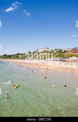 BOURNEMOUTH, UK - July 08, 2022. People enjoying summer by the sea on a sandy beach. Bournemouth, Dorset, UK Stock Photo