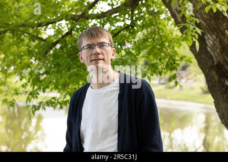 Portrait Of Tall Blond 40 Yo Man In Eyesight Glasses, Smiling Looking At Camera, Green Tree And Lake On Background. Horizontal Plane Stock Photo