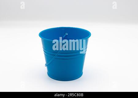 Blue metal miniature bucket on white background Stock Photo