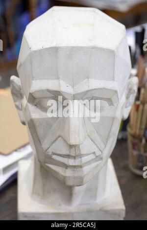 photo of a plaster head for painting on a table Stock Photo