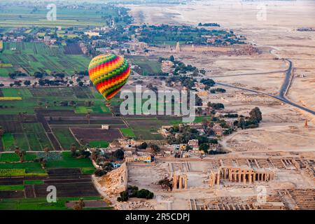 Aerial view of beautiful hot air balloon flying over the ruins Temple of the Ramesseum for Pharaoh Ramses II at Valley of The Kings in Theban Stock Photo