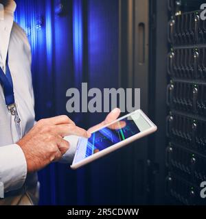 Put your companys network safety in the right hands. an unrecognisable man using a digital tablet while working in a server room. Stock Photo