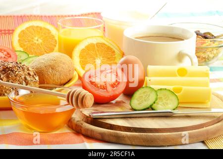 Breakfast including rolls, egg, cheese, coffee and orange juice on the table Stock Photo