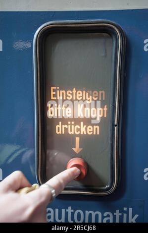 Automatic door, please press button to board, historic tram, Munich, Bavaria, Germany Stock Photo